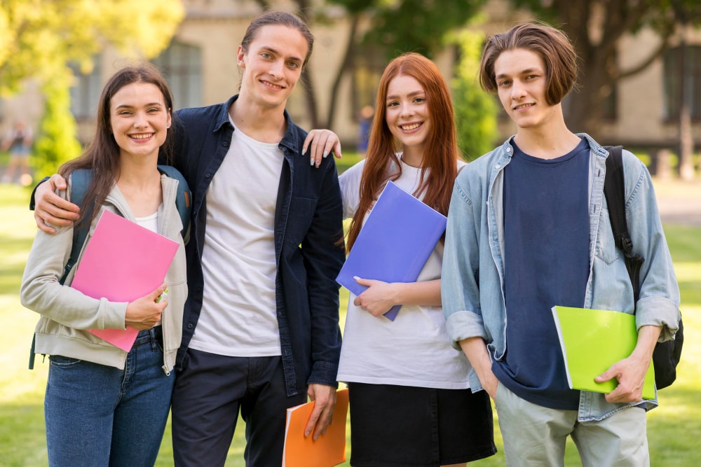 positive-teenagers-posing-together-university-min