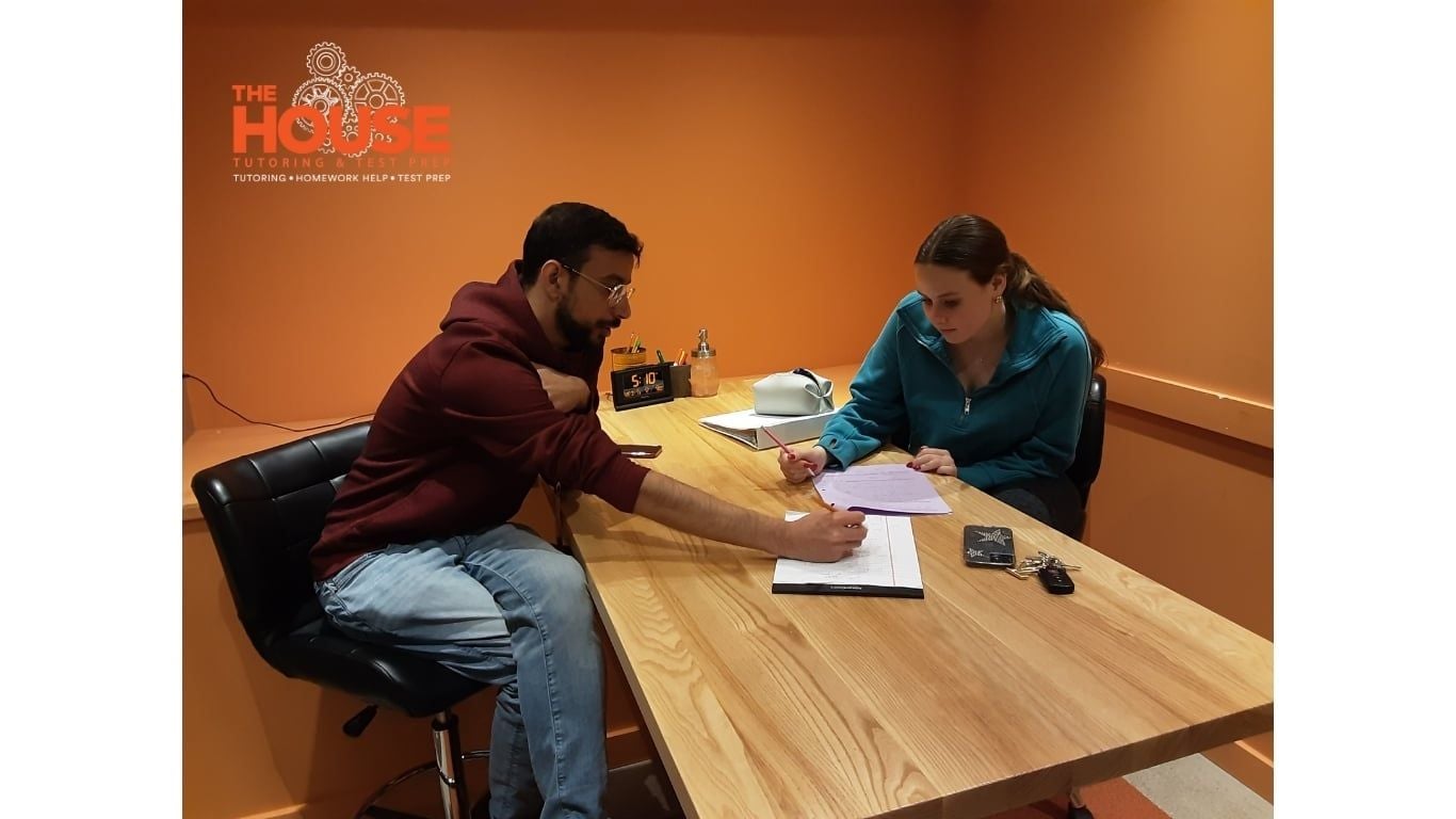 Tutor working with a student at The House